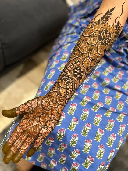 Another view of Nida's stunning bridal arm henna. The design combines circular mandalas, net patterns, and floral elements.
