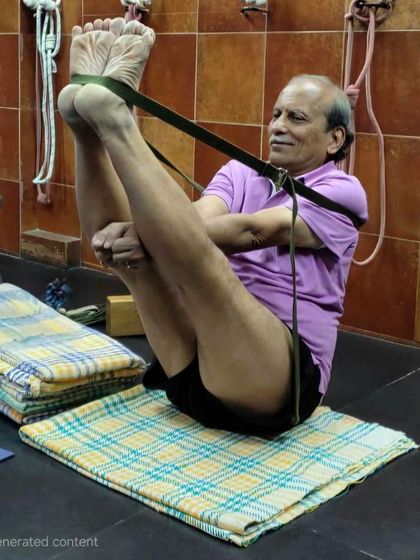 Practicing a variation of Navasana (Boat Pose) with a strap, a common sequence in my online classes to build core awareness and strength.