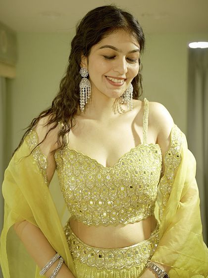 A close-up of the mirror-work blouse from the lime green lehenga set. I pay close attention to craftsmanship and detail to ensure your outfit is truly special.