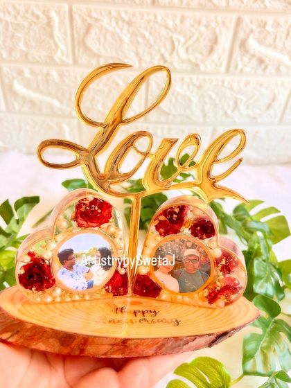 Holding the upcycled anniversary frame. It’s a testament to how creativity can give old items a new, meaningful life.