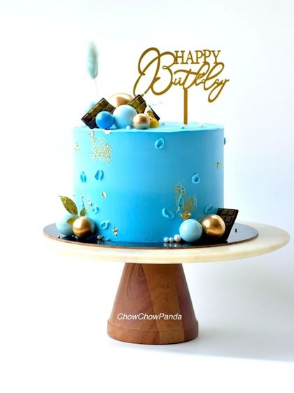 A handsome Choco Mocha cake designed for him. The solid blue buttercream is accented with gold leaf, chocolate pieces, and decorative spheres.