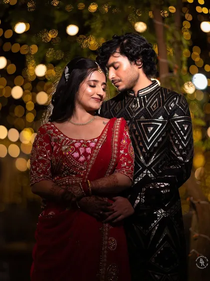 Under a canopy of golden lights, this moment feels like it's from a movie. I love capturing the romance of sangeet nights, where the soft bokeh glow makes everything feel magical and intimate.