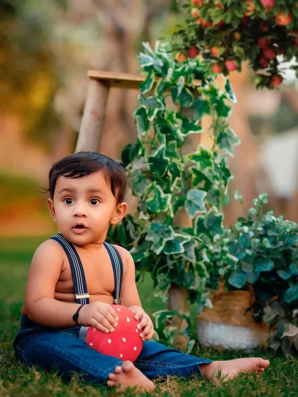 A curious moment with a prop mushroom. Outdoor sessions are full of discovery and wonder for little ones.