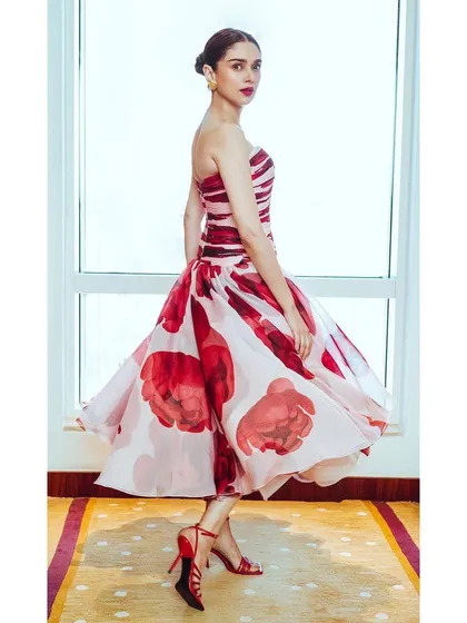 This Gauri and Nainika floral gown is like a wearable watercolor painting. The strapless design and full, flowing skirt are perfect for a spring event or a movie premiere.