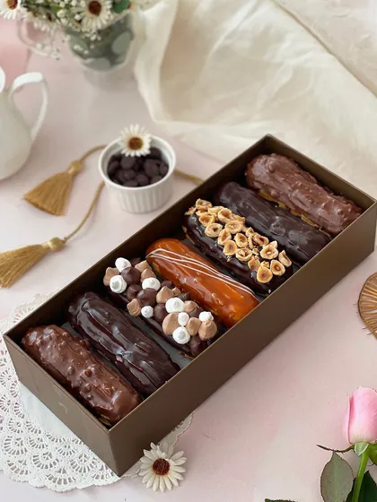 A box of seven, a taste of bliss. Our assorted eclairs box includes flavors like Classic, Rocher, Hazelnut, Caramel, and Blackforest.