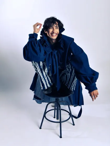 Even in high fashion, there's room for joy. This candid laugh breaks the tension and adds a human element to the avant-garde styling.