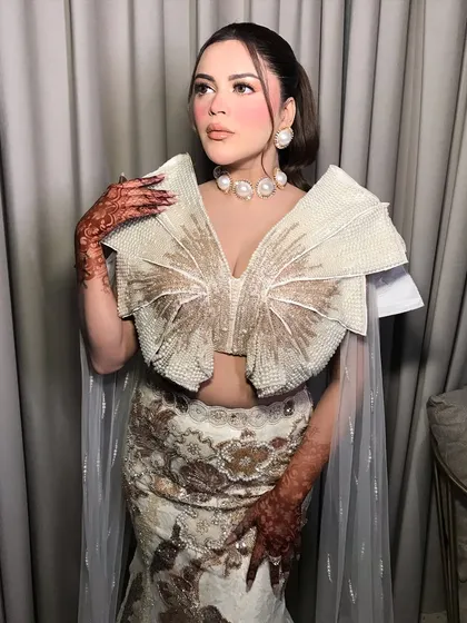 This client is wearing a high-fashion pearl-encrusted outfit. We styled it with a bold, oversized pearl choker and matching earrings.