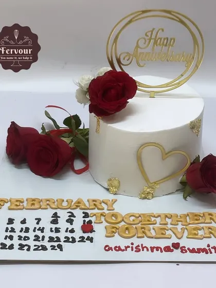 A popular trending design, this anniversary cake features a calendar marking the special date. This chocolate mousse cake is decorated with fresh red roses for a romantic touch.
