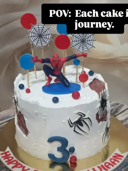 A dynamic Spider-Man cake for a 3rd birthday. This design features the web-slinger in action, complete with spider webs and city-themed toppers.