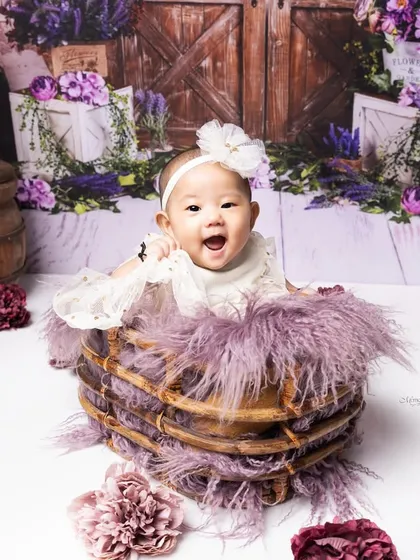 This setup, this moment, this memory. A happy 6-month-old in a basket, surrounded by a beautiful lavender-themed floral set.