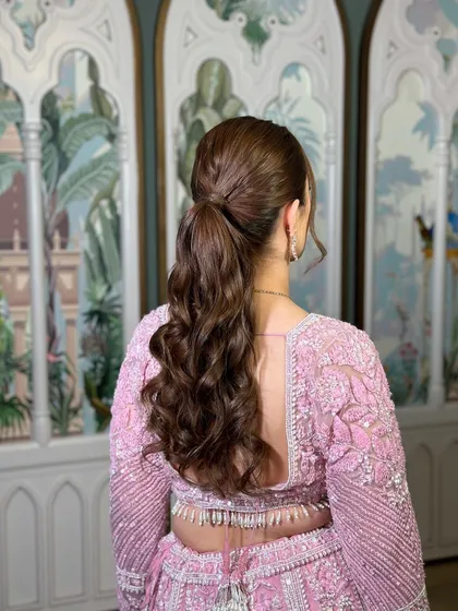 A back view of the soft curls ponytail, perfect for a reception or cocktail party.