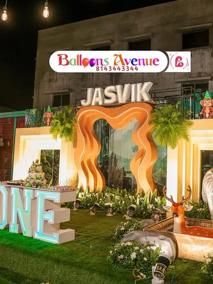 Another perspective of the large-scale outdoor jungle party, highlighting the lighting and the arrangement of multiple animal figures.