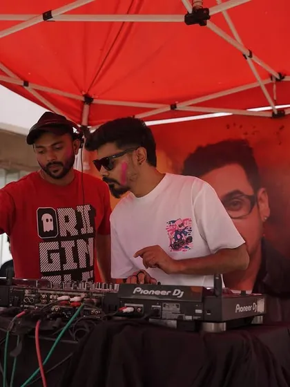 DJs at the console during our Holi Utsav. I ensure the music is the driving force of the party, with a lineup that keeps the energy going all day.