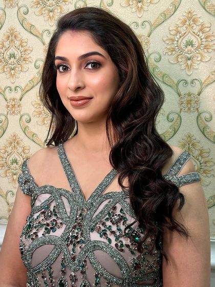 A direct portrait that captures the modern beauty of this look. The makeup is subtle yet impactful, perfect for a chic evening affair.