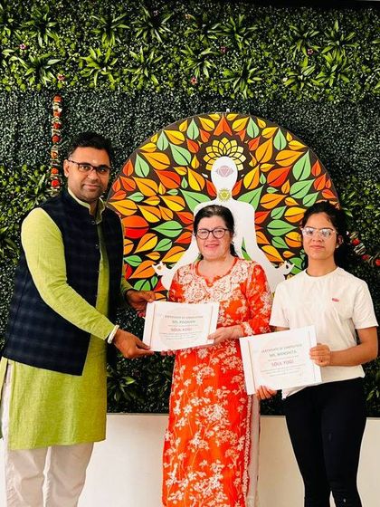 An instructor proudly presents certificates to two participants. These moments celebrate the dedication and personal growth achieved during our workshops and retreats.
