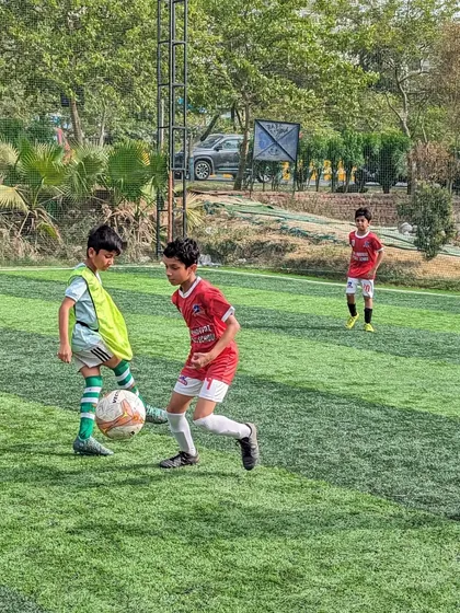 A one on one duel for the ball, a common sight in our competitive youth football matches.