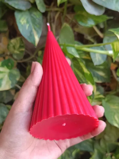 The base of the red ribbed pillar candle, showing its shape.