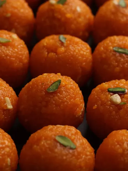 A close-up of Motichoor Ladoo, another festive favorite. The macro shot highlights the tiny, pearl-like texture of the ladoo.