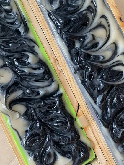 The intricate swirls on top of our Charcoal Detox soap batter. Each bar is a unique piece of art.