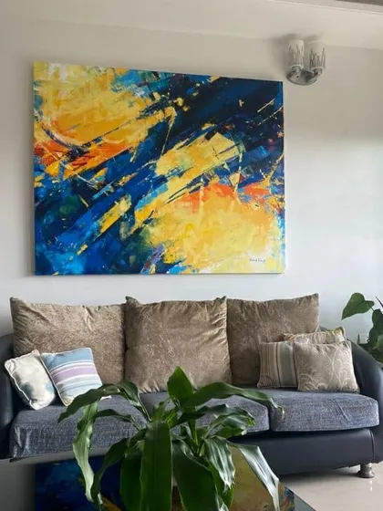 This abstract piece, 'Confluence', found its perfect home. It shows how a bespoke abstract can completely define a living room's atmosphere. We can work with your color palette and style to create a piece that feels like it was always meant to be there.