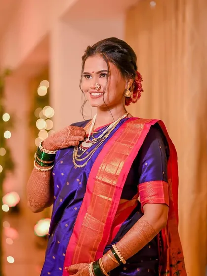 A candid shot of the bride's happiness. The makeup is designed to look fresh and radiant, capturing her joy perfectly.