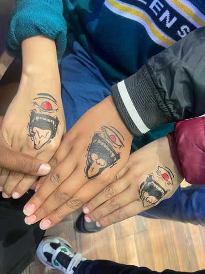 A group of friends showing off their matching "Sukuna" tattoos from the popular anime Jujutsu Kaisen. We stay up to date with the latest trends.