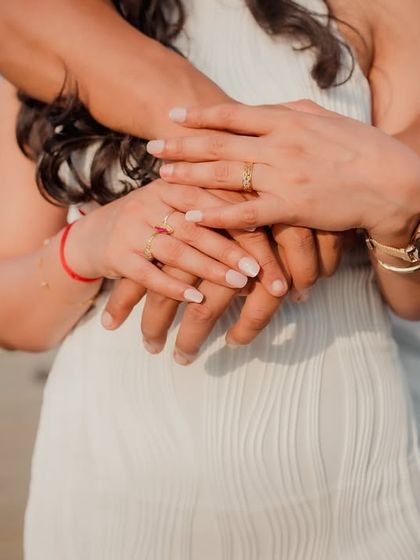 A close-up of the couple's hands intertwined in a loving embrace. This detail shot beautifully symbolizes their connection and unity.