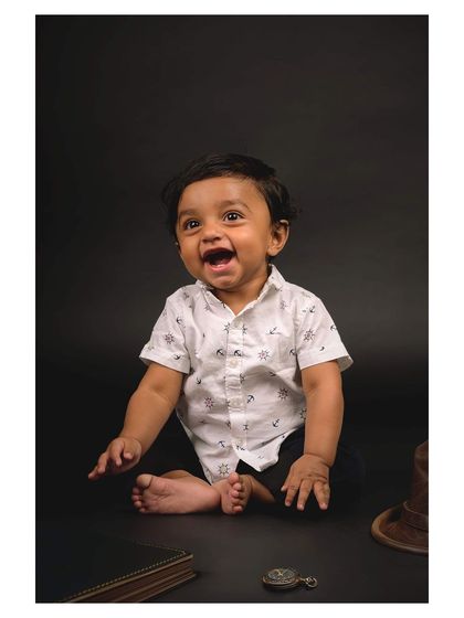 A candid shot of a baby laughing during a studio session. My approach is to create a fun environment where children can be themselves.