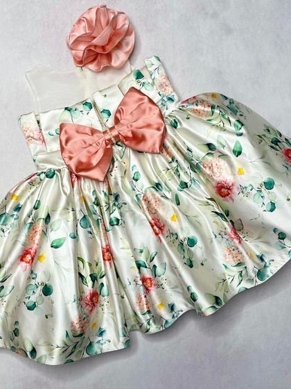 Our "Floral Grace" dress is a picture of classic charm. This version features a beautiful satin floral print with a large, matching bow at the waist.