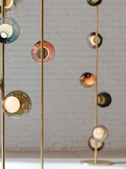 The Bocci stem series with colorful 28 series pendants installed in a vertical, floor-to-ceiling configuration, creating a vibrant column of light.