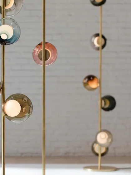 A detail shot of the Bocci 28 column installation, showing the brass stems and the colorful, hand-blown glass pendants. This is a perfect solution for spaces with high ceilings or narrow areas.