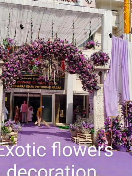 A grand entrance for a Gurudwara wedding. We crafted a massive arch of purple flowers, complemented by matching arrangements and drapes, to create a royal welcome for all the guests.