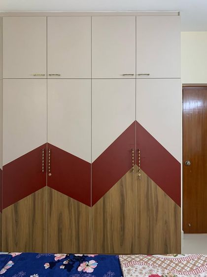 The kids' bedroom in this apartment features a playful, zig-zag pattern on the wardrobe using three different laminates. It's a great example of how we can create fun and unique designs on a budget.