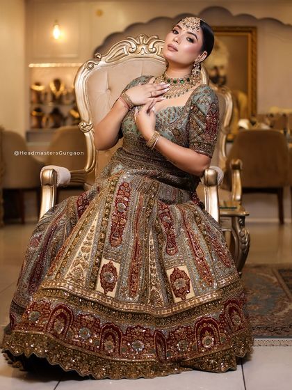 A royal portrait from our bridal campaign. The model is seated on a throne-like chair, and her makeup is done to perfection, exuding luxury and sophistication.