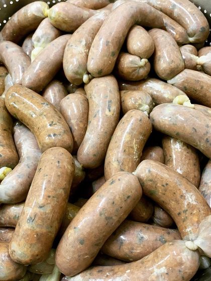 A batch of our freshly stuffed Coorg-spiced sausages, ready for cooking. You can see the herbs and spices mixed into the pork, promising a flavorful, handmade product.