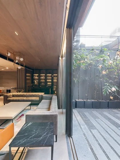 The ultimate blend of indoor and outdoor living. Large windows flood this entertainment room with light, while the adjacent courtyard with sculpture tree lighting creates a magical ambiance.