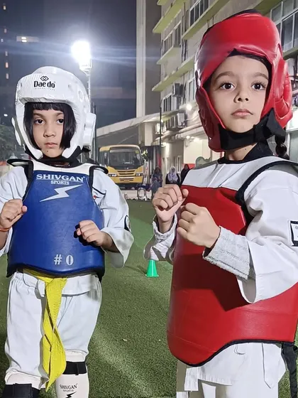 Ready for battle. Two of our youngest students geared up in their hogu (chest guard) and helmets, ready for a friendly sparring match. This is where they learn courage and respect.