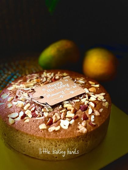A special "Happy Birthday Mommy-to-be" tag on this wholesome vegan mango nuts cake.