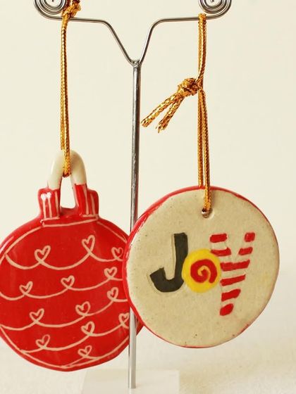 These flat, disc-shaped ornaments are hand-painted with joyful messages and patterns. They are lightweight and perfect for hanging on any tree.