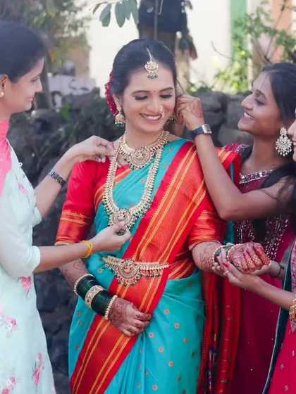 A heartwarming candid moment as the bride's friends and family help her with her final touches, showing the love and support surrounding her on her wedding day.