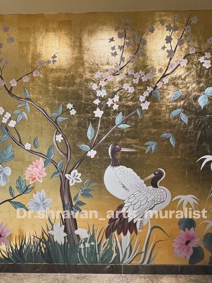 A fusion of styles, this mural features Chinese-inspired art with birds and cherry blossoms painted over a full wall of gold lustre, creating an incredibly rich and opulent effect.