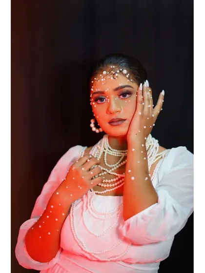 The pearl-adorned look under red lighting, creating a dramatic and moody effect.