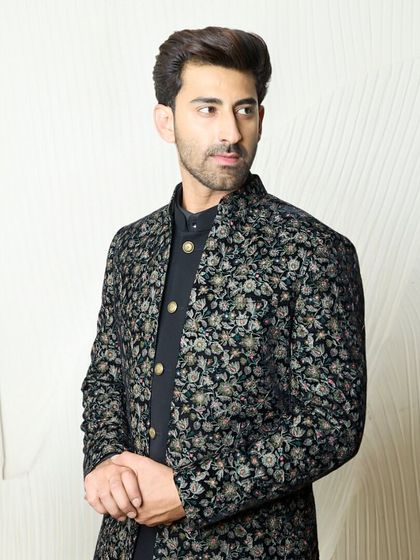 A full view of the black floral embroidered jacket set. This versatile ensemble is perfect for any event, from a family get-together to a sangeet night.