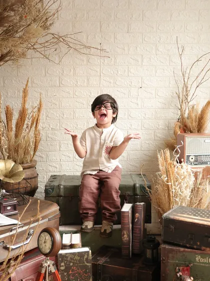 A big, expressive gesture from the birthday boy, full of energy and excitement.