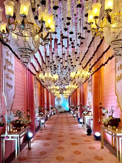 The entrance passage to the Shri Yantra wedding, lined with grand chandeliers and traditional banners. We believe in creating an immersive experience from the very first step.
