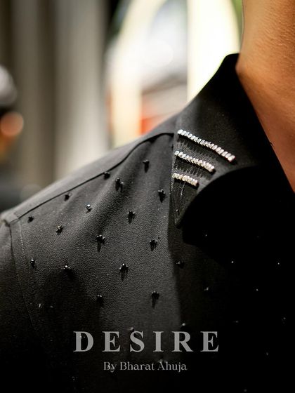 A close-up of the shoulder detail on the gun-embroidered shirt. I use a combination of black beads and silver crystals to add texture and a subtle, masculine sparkle.