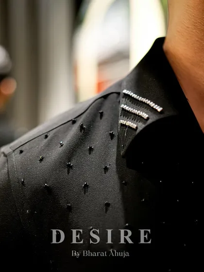 A close-up of the shoulder detail on the gun-embroidered shirt. I use a combination of black beads and silver crystals to add texture and a subtle, masculine sparkle.