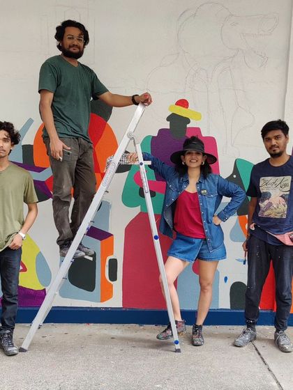 Team Berserk on site, taking a moment to pose during the creation of a colorful mural.