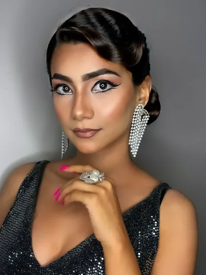 The full effect of this glamorous party look. The sleek hair, sparkling dress, and bold makeup come together to create an unforgettable, red-carpet-ready style.