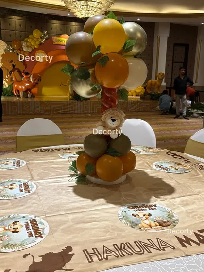 A guest table setup with the stage visible in the background, showing how the theme is carried throughout the entire venue.